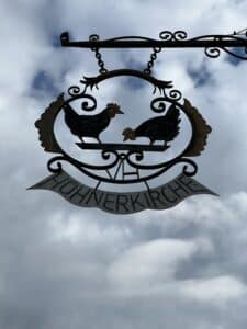 Das Wappen und Schild der Hühnerkirche